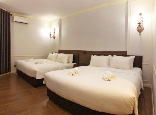 Ein Bett oder Betten in einem Zimmer der Unterkunft The MACEO Hotel