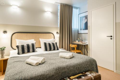 a hotel room with a bed with two towels on it at Bob W Kluuvi in Helsinki