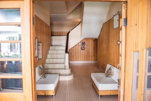 a room with two beds and a staircase at SETHI's HOMESTAY in Srinagar