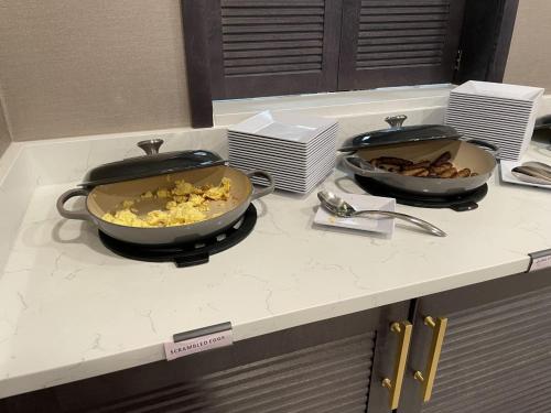 two pans sitting on a kitchen counter with food at Hyatt Place Tulsa/Downtown in Tulsa
