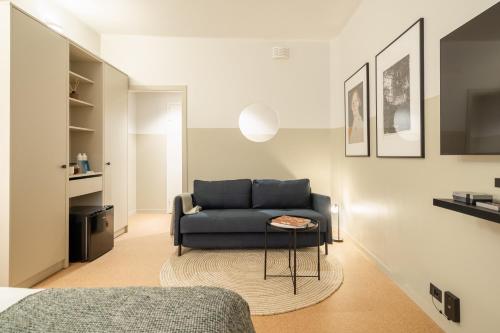 a living room with a couch and a table at Bob W Kluuvi in Helsinki