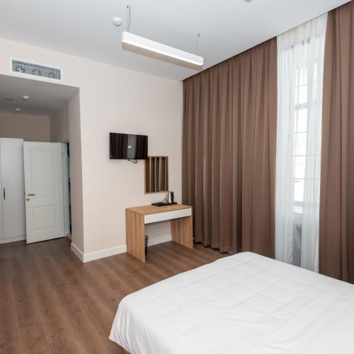 Postel nebo postele na pokoji v ubytování OLF Hotel