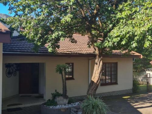 a house with a tree in front of it at Groenewald's Haven in Nelspruit