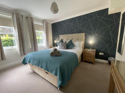 a bedroom with a bed with a blue blanket at Maiden Moor in Keswick