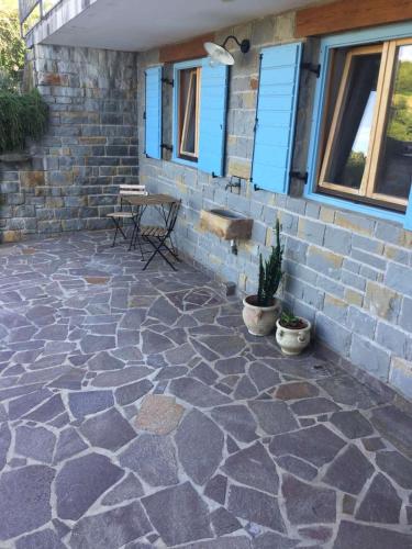 a patio with a stone floor and a building at Fig&Lavender Apartment in Šmarje