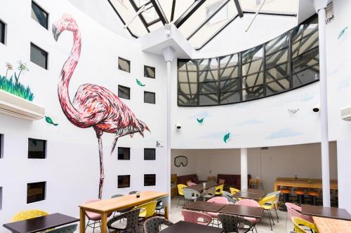 a pink flamingo is painted on the side of a building at Victoria Garden Bordeaux Centre in Bordeaux