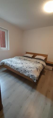 a bed in a white room with a bed sidx sidx sidx at Carlitos in Gospić
