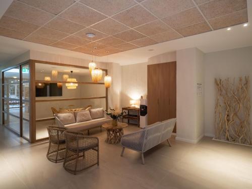 a living room with a couch and chairs at PALASIET Wellness Clinic&Thalasso 4 SUP in Benicàssim