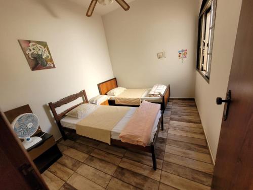 Tempat tidur dalam kamar di Casa de Temporada Piumhi