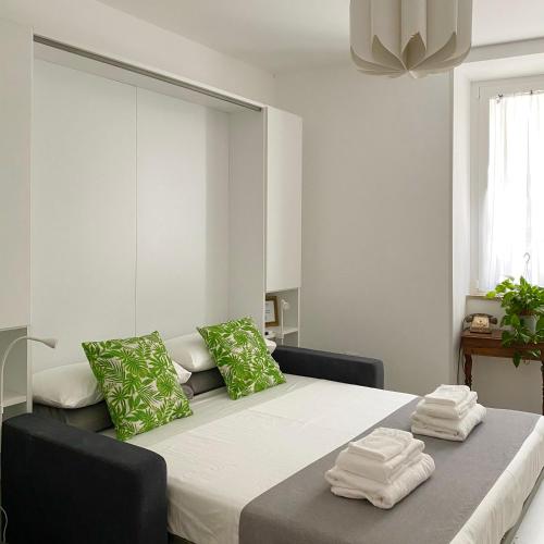 a bedroom with a large bed with green pillows at Casa Vita Scilla in Scilla