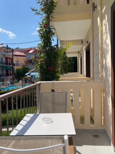 a white table and chair on a balcony at Valentinos House in Parga