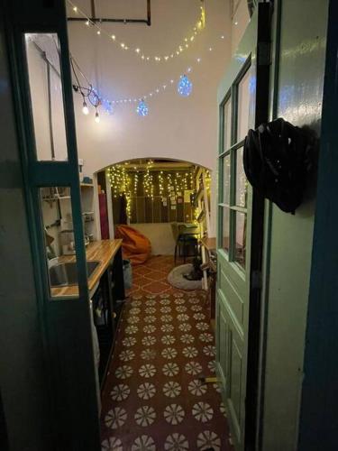a hallway leading to a room with lights and a door at Mini Loft 1 en El Circulo in Guatemala