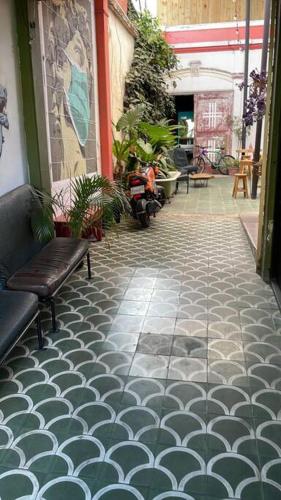 a tile walkway with a bench on a street at Mini Loft 1 en El Circulo in Guatemala