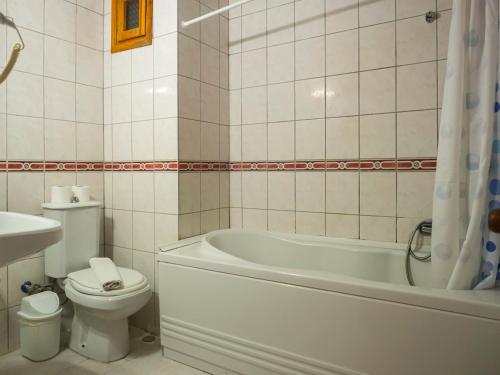 a bathroom with a tub and a toilet and a sink at Tal Beach Hotel in Beldibi