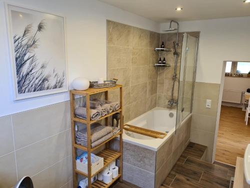 a bathroom with a shower and a bath tub at Apartment am Grimmsteig in Nieste