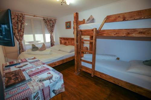 a bedroom with two bunk beds and a table at Hunter in Štúrovo