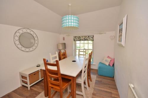 a dining room with a table and chairs at Mayrose Cottage, Charming Cornish Cottage for the perfect escape... in Camelford