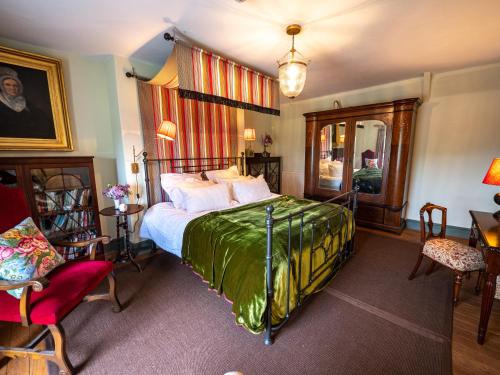 a bedroom with a bed and a table and chairs at Sawcliffe Manor Country House with Spa, Free Parking, Catering, Self Checkin, Farmstay in Scunthorpe