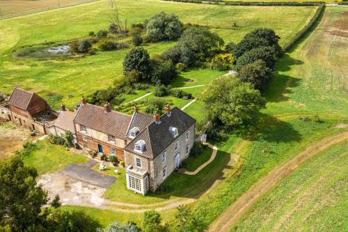 una vista aérea de una casa antigua en un campo en Sawcliffe Manor Country House with Spa, Free Parking, Catering, Self Checkin, Farmstay en Scunthorpe