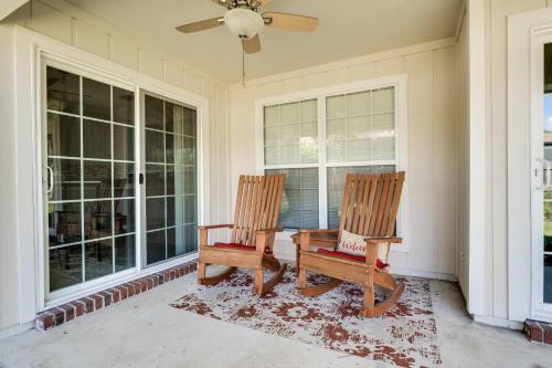 two chairs sitting on a porch with windows at Bermuda Drive Abode in Fleming Island