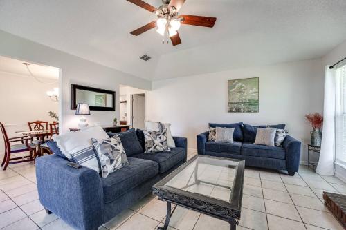 a living room with two blue couches and a ceiling fan at Bermuda Drive Abode in Fleming Island