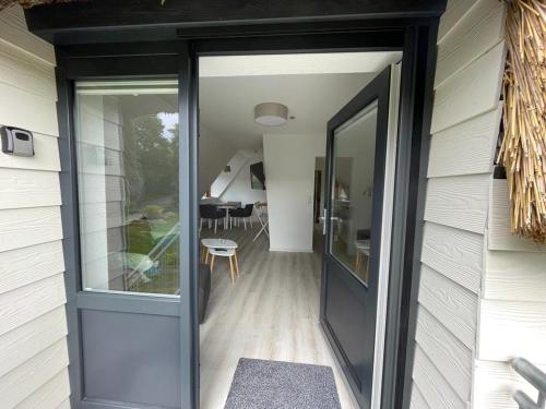 a sliding glass door on a house with a dining room at Burgerblick in Brodersby