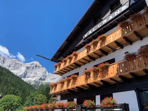 a building with flower boxes on the side of it at Hotel Valgranda Wellness & Spa in Val di Zoldo