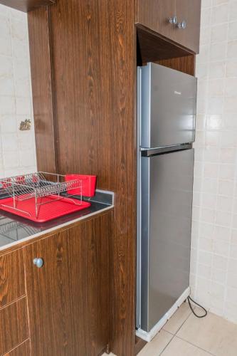 a kitchen with a stainless steel refrigerator on a counter at RESIDENCE OLIE OFFICIEL in Douala