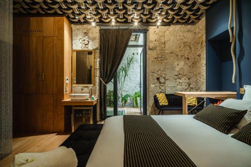 a bedroom with a king sized bed and a window at Airb&Sexy in Béziers
