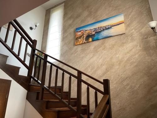 a staircase with a painting hanging on a wall at Sozopolis Cliffs Luxury Seaview Villa in Sozopol