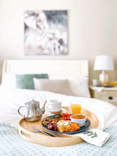 a tray of breakfast food on a bed at Lizzys Little Kitchen Town Accommodation in Listowel