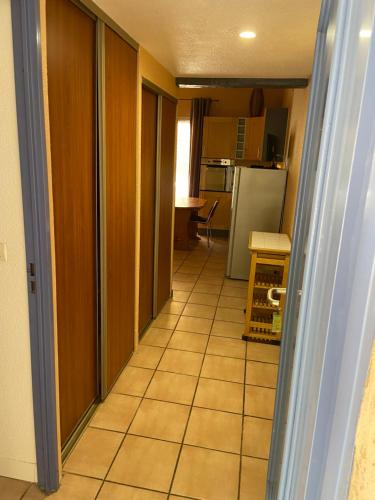 a hallway leading to a kitchen with a floor at Domaine De La Bégude in Fayence