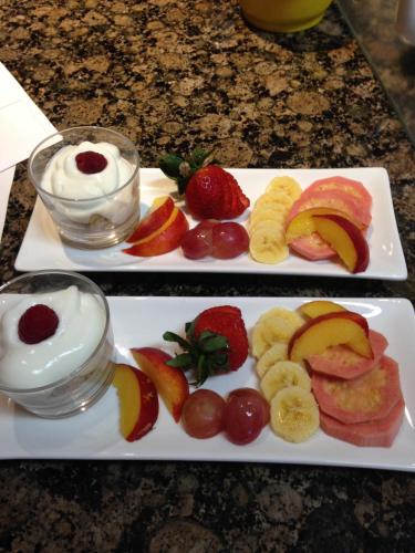 two plates of fruit and yogurt on a table at Edenwood House in George