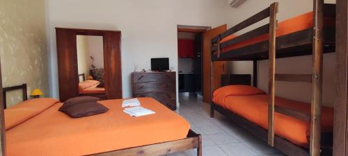 a bedroom with two bunk beds and a mirror at Al Cuore del Borgo in Castelmezzano
