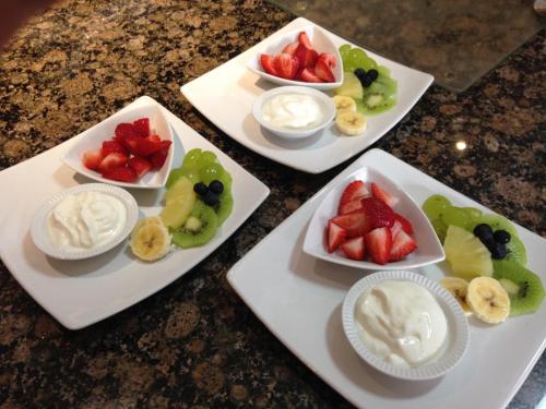 four white plates with different types of fruit on them at Edenwood House in George