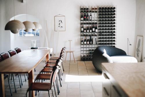 a dining room with a table and chairs and wine racks at MÜHLENHOF ROOMS boutique bed & breakfast in Langenlois