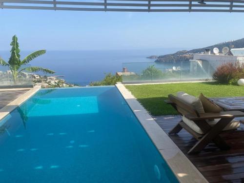 a swimming pool with a table and a chair next to it at Villa Aleph-Kiralık Müstakil havuzlu lüx villa in Bodrum City