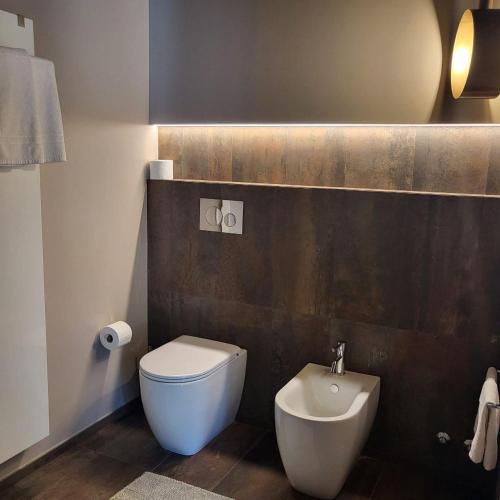 a bathroom with a white toilet and a bidet at Villa Ca' Viola Rimini in Rimini