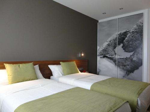 two beds sitting next to each other in a bedroom at Hotel Rural Gaintza in Getaria