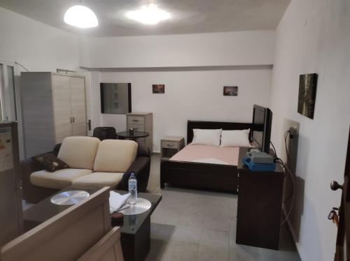 a small living room with a bed and a couch at Timbaki'Theodosia'T Brothers in Tympáki