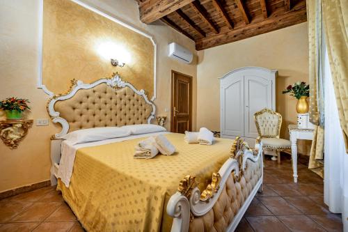 a bedroom with a large bed with a yellow bedspread at Katti House in Florence