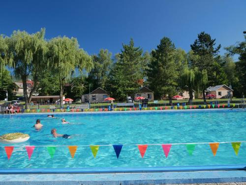 a group of people swimming in a swimming pool at Camping Rožnov in Rožnov pod Radhoštěm