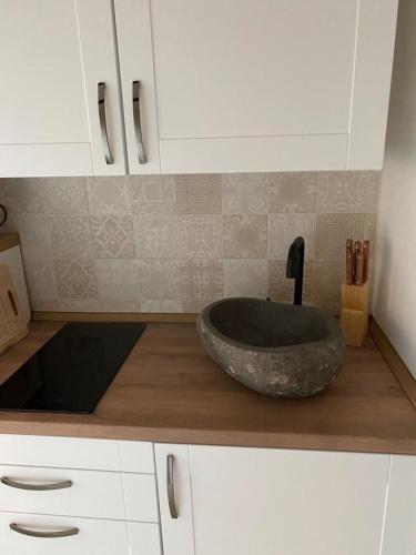 a bathroom with a stone sink on a counter at Kleines Harztor in Halberstadt
