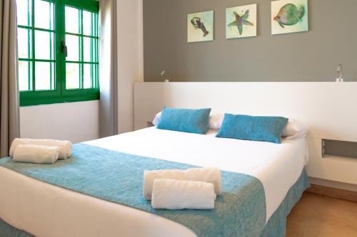 a hotel room with two beds and a window at Hyde Park Lane in Puerto del Carmen