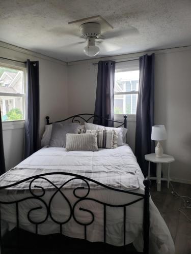 a bedroom with a bed with a black frame at Lake View Cottage on Lake Erie in Ashtabula