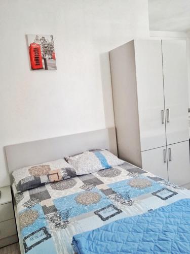 a bedroom with a bed and a phone booth on the wall at Apartments Iva in Star Dojran