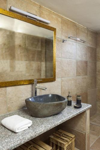 a bathroom with a sink and a mirror at Mani Tower by Olive Villa Rentals in Oítilon