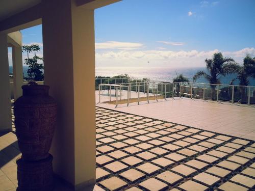 a balcony with a view of the ocean from a house at The Homestead Margate - South Africa in Margate