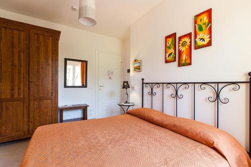 a bedroom with a bed with an orange blanket at Osteria da Cesare e Locanda in Castel San Pietro Terme