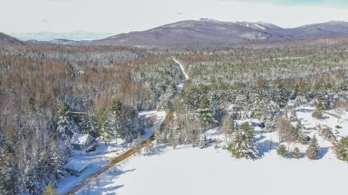an aerial view of a snow covered forest at Chalet Le Convivial Tremblant in Lac-Superieur